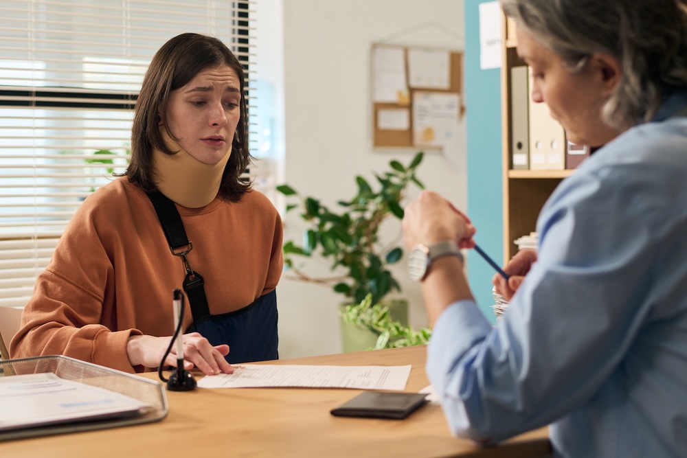 an injured woman talking with a lawyer