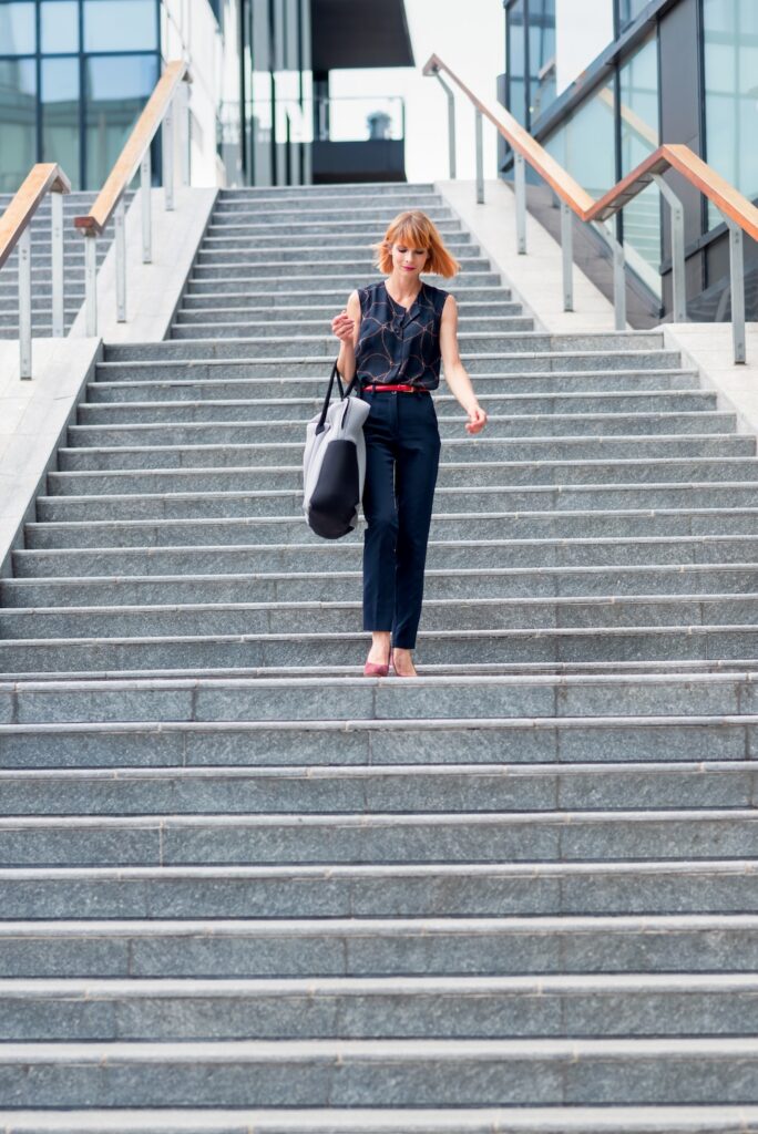 a woman walking down some stairs